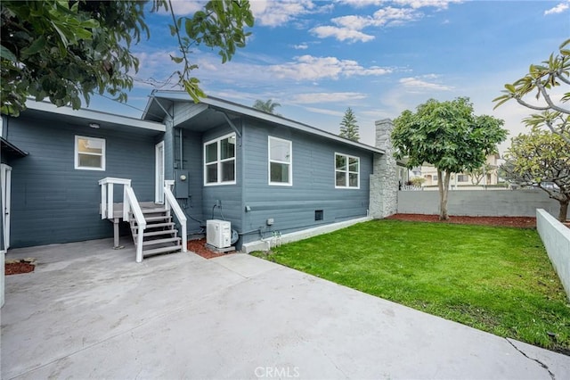 rear view of house with a lawn and cooling unit