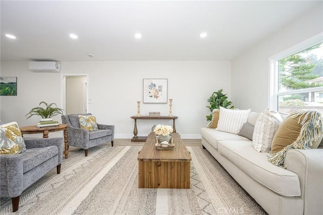 living room with light wood-type flooring and a wall mounted air conditioner