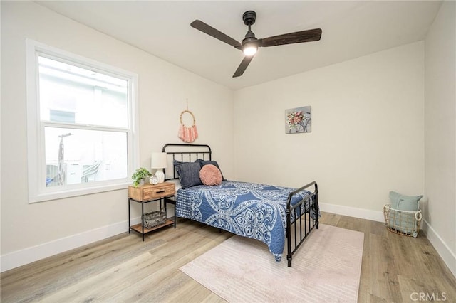 bedroom with ceiling fan and wood-type flooring