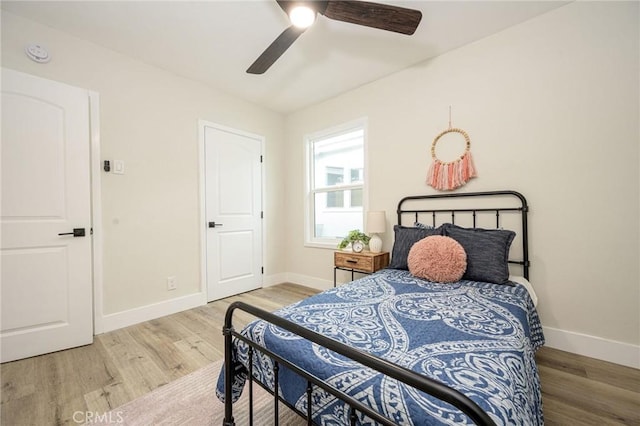 bedroom with ceiling fan and hardwood / wood-style floors