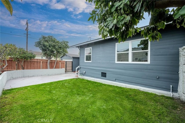 rear view of property with a patio area and a yard