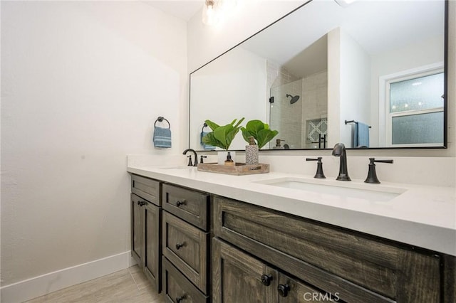 bathroom with vanity and tiled shower