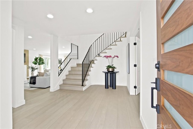 foyer entrance with light hardwood / wood-style floors