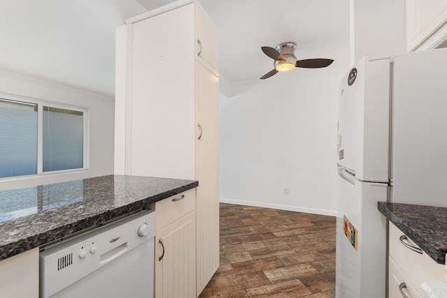 kitchen featuring ceiling fan, white cabinets, dark stone countertops, and white appliances