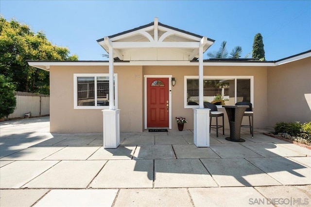 view of exterior entry featuring a patio