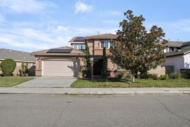 view of front of property with a garage and solar panels