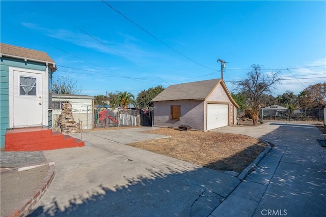 exterior space featuring a garage and an outbuilding