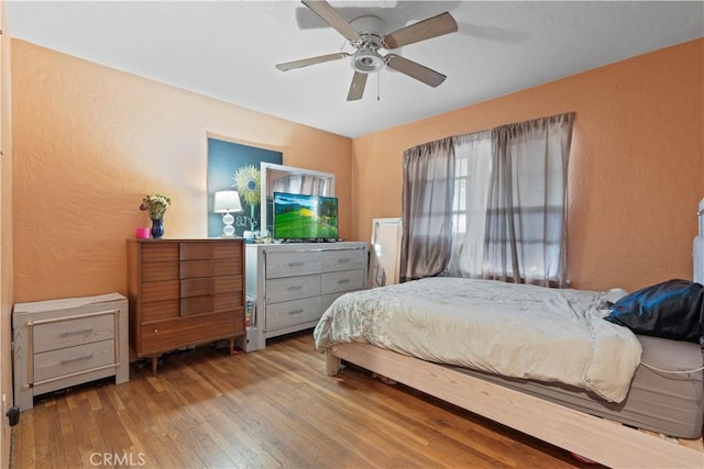 bedroom featuring ceiling fan and light hardwood / wood-style floors