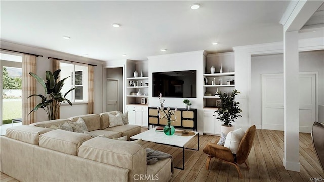 living room featuring light hardwood / wood-style flooring and crown molding