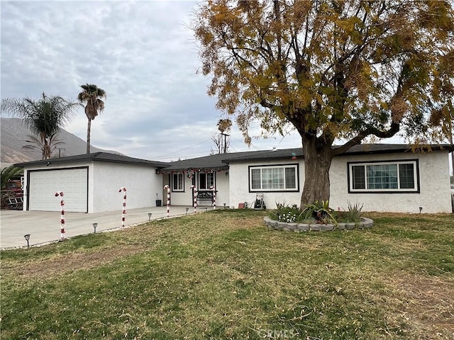 ranch-style house with a garage and a front lawn