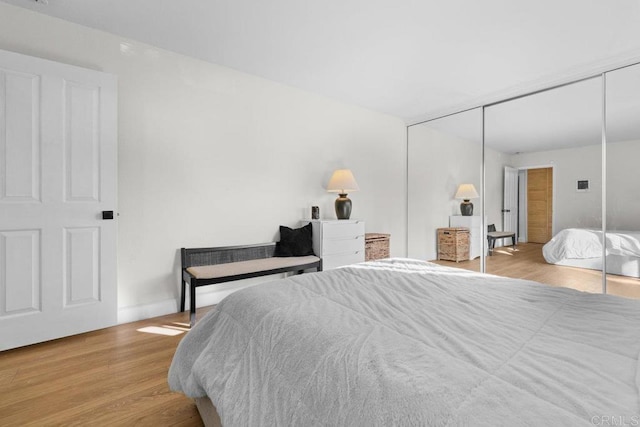 bedroom featuring a closet and light hardwood / wood-style floors