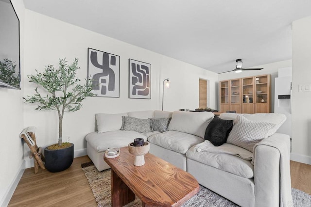 living room with light wood-type flooring and ceiling fan