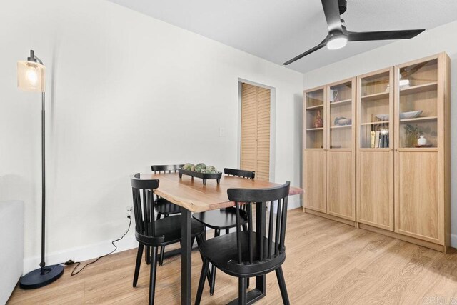 dining room with ceiling fan and light hardwood / wood-style flooring