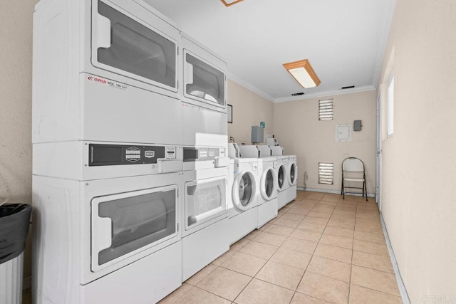 laundry room with washer and dryer, light tile patterned floors, stacked washer and clothes dryer, and ornamental molding