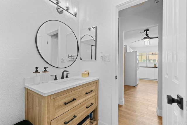 bathroom featuring ceiling fan, vanity, and hardwood / wood-style floors