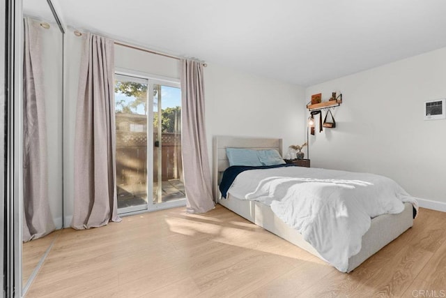 bedroom featuring light hardwood / wood-style flooring and access to outside