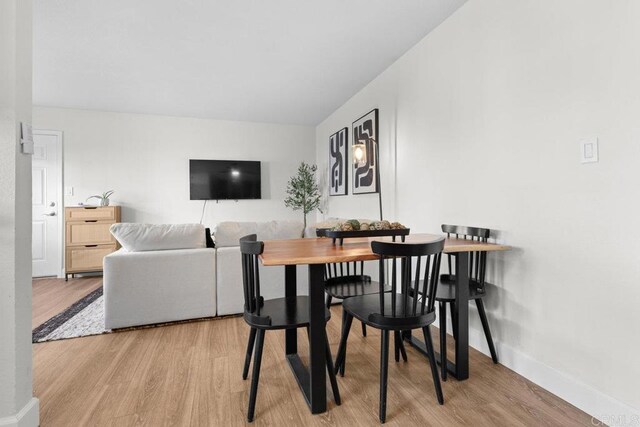 dining area with light hardwood / wood-style floors