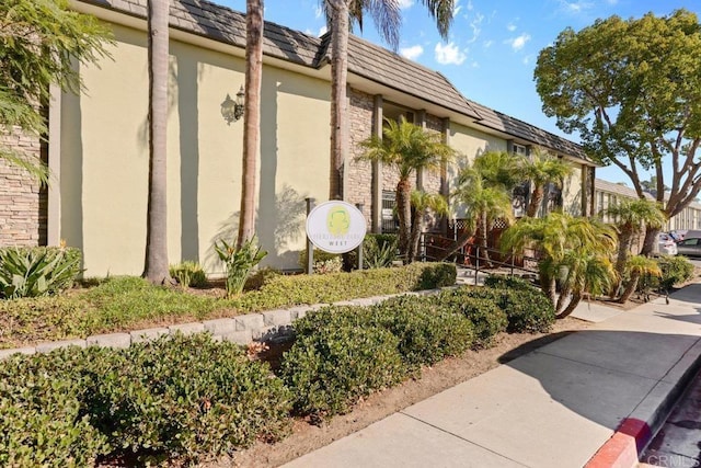 6602 Beadnell Way Unit 14, San Diego, CA 92117 - view of side of home featuring stucco siding and mansard roof