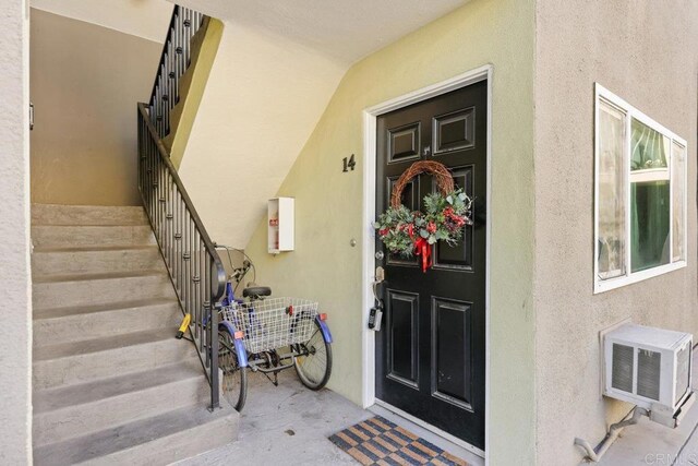 6602 Beadnell Way Unit 14, San Diego, CA 92117 - entrance to property featuring stucco siding and a wall mounted AC