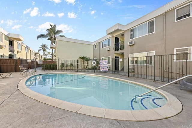 6602 Beadnell Way Unit 14, San Diego, CA 92117 - community pool featuring a residential view, an AC wall unit, and a patio area
