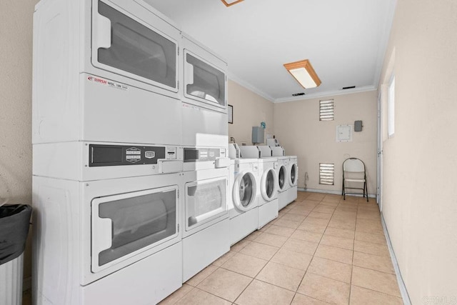 6602 Beadnell Way Unit 14, San Diego, CA 92117 - community laundry with stacked washing machine and dryer, light tile patterned flooring, ornamental molding, and washing machine and dryer