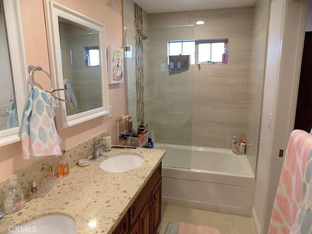 bathroom with tiled shower / bath, tile patterned floors, and vanity