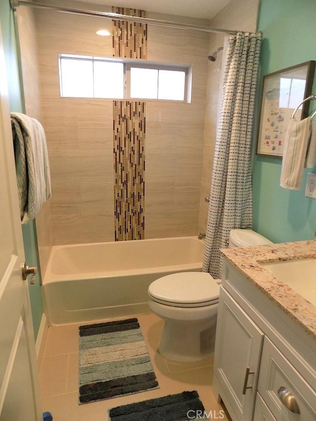 full bathroom featuring toilet, tile patterned flooring, vanity, and shower / bath combo with shower curtain