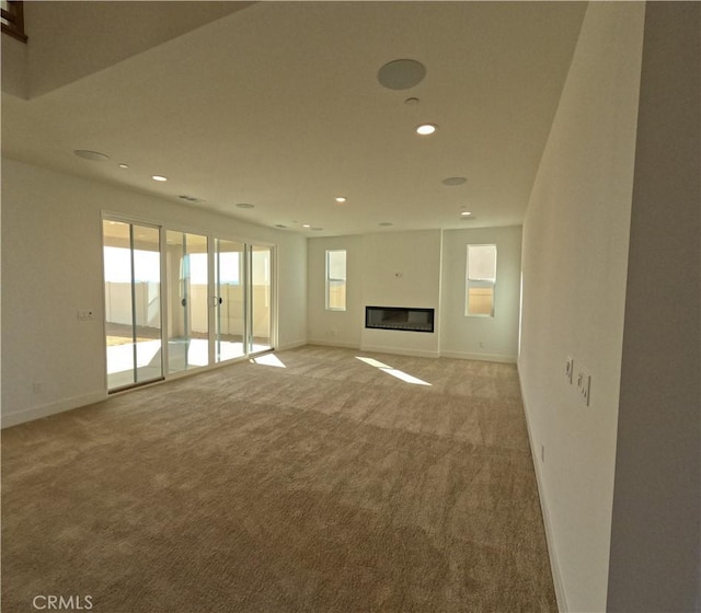 unfurnished living room featuring light carpet