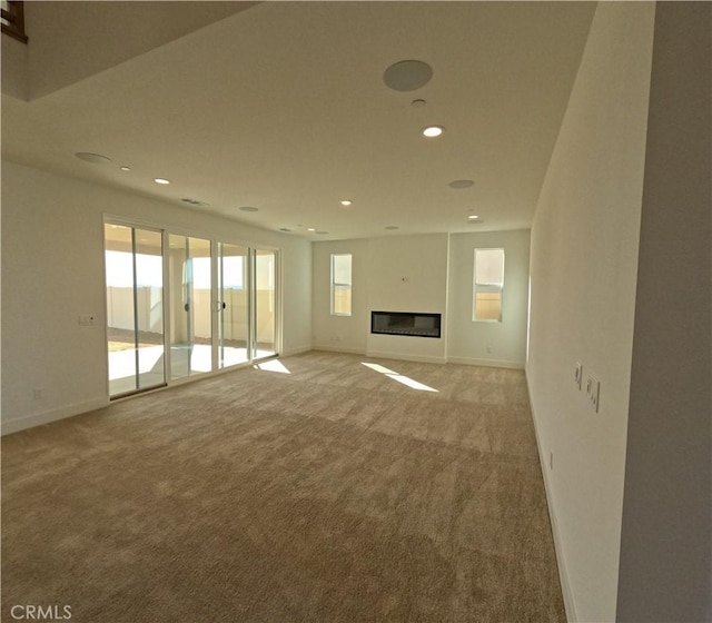 unfurnished living room with light colored carpet