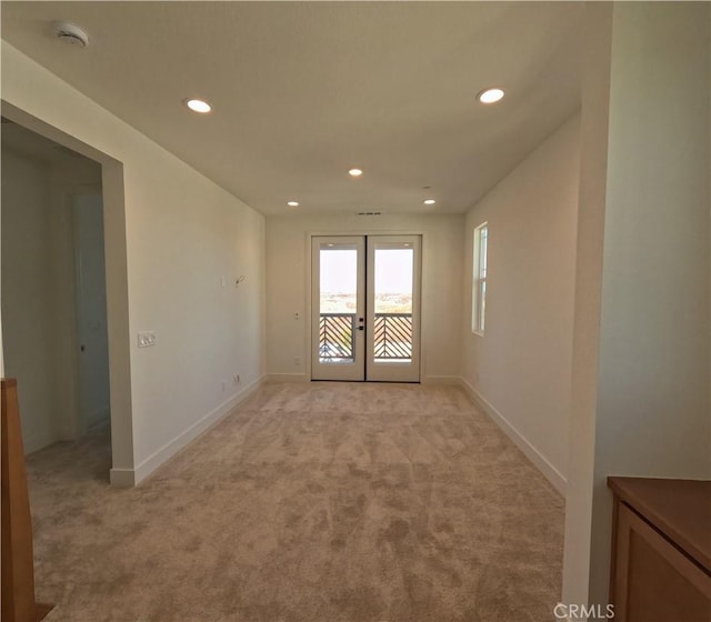 carpeted spare room with french doors