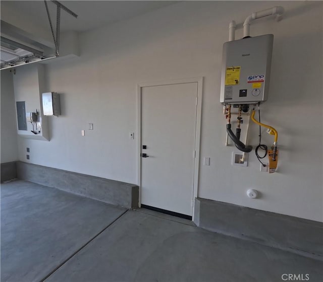 garage featuring water heater and electric panel