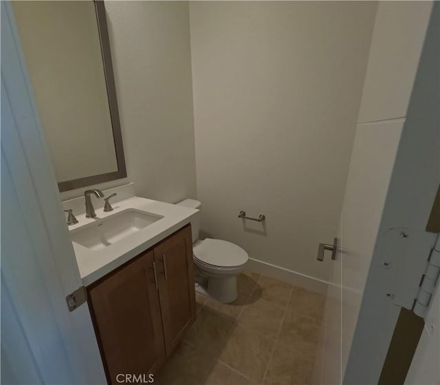 bathroom featuring toilet and vanity