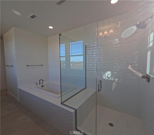 bathroom featuring plus walk in shower and tile patterned flooring