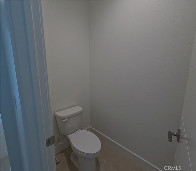 bathroom featuring toilet and tile patterned flooring