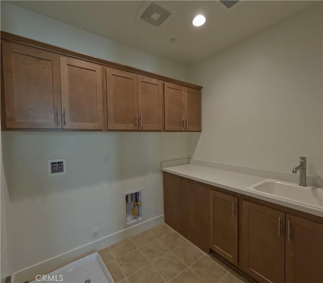 laundry room with cabinets, hookup for a gas dryer, sink, hookup for a washing machine, and light tile patterned floors