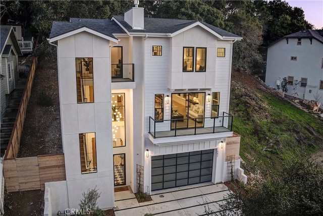 view of front of house featuring a balcony and a garage