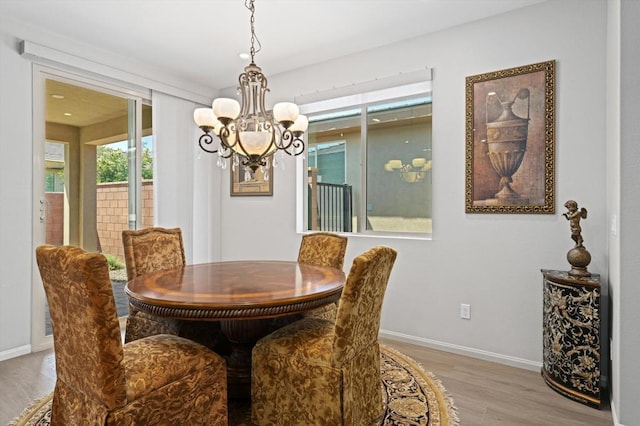 dining area featuring a chandelier and light hardwood / wood-style floors