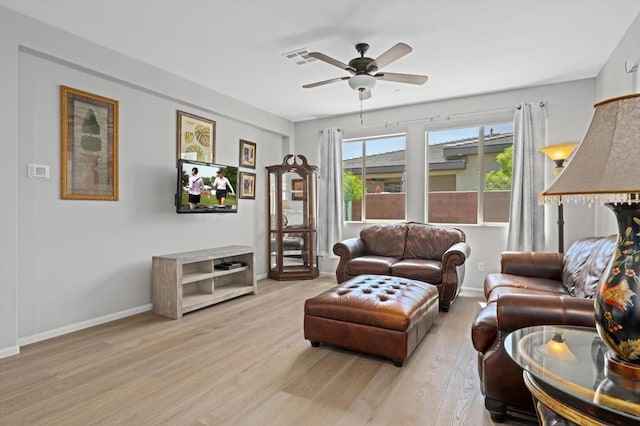 living room with ceiling fan and light hardwood / wood-style floors