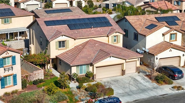 view of front facade with solar panels and a garage