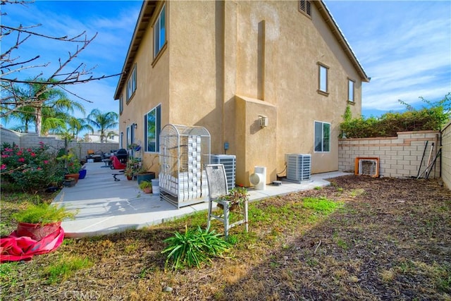 back of property featuring a patio area and cooling unit