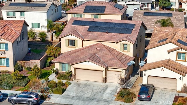 view of front of home with a garage and solar panels