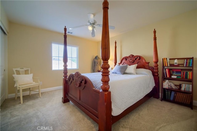 carpeted bedroom with ceiling fan and a closet