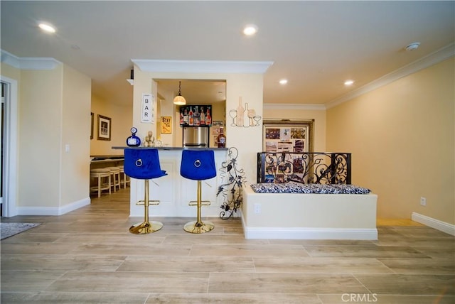 bar featuring fridge and ornamental molding