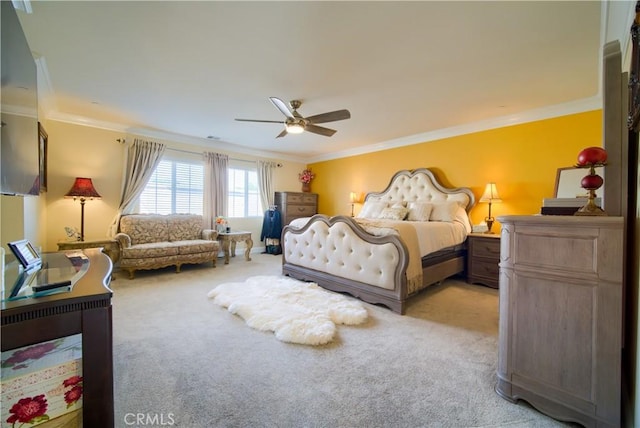 carpeted bedroom featuring ceiling fan and crown molding