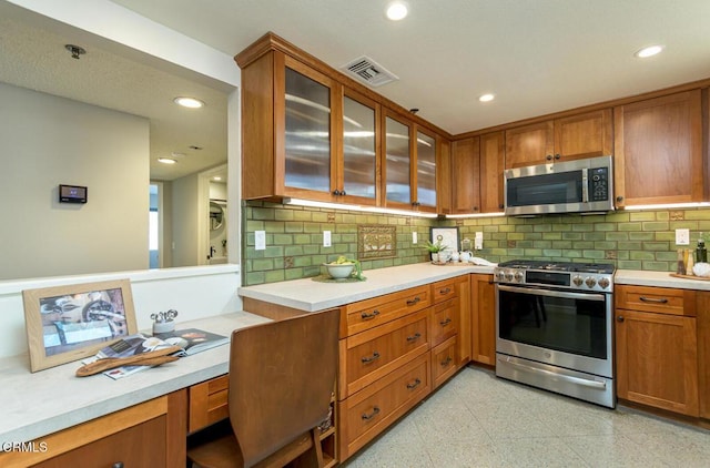 kitchen with backsplash and stainless steel appliances