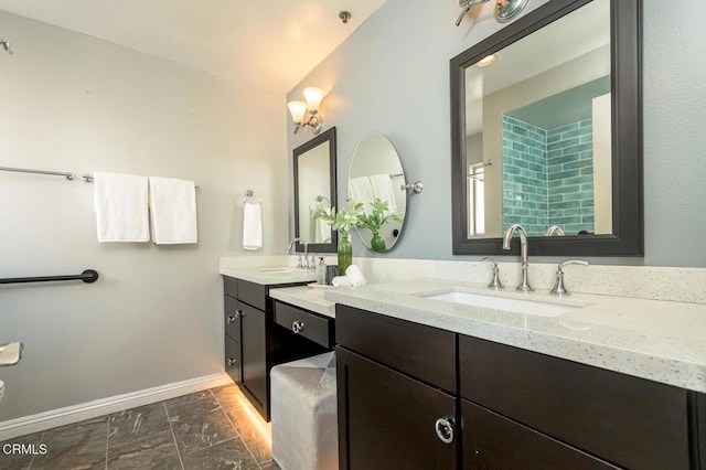 bathroom featuring lofted ceiling and vanity