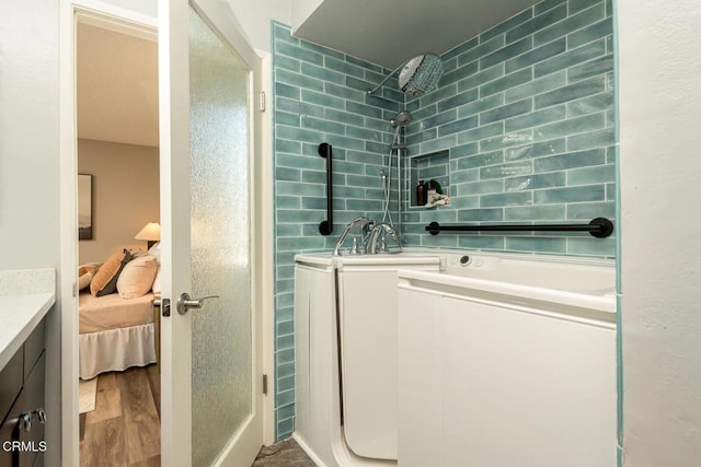 bathroom featuring a shower, wood-type flooring, and vanity