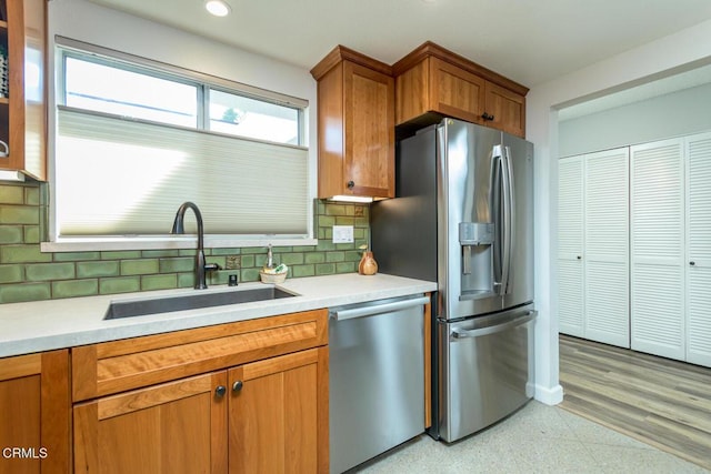 kitchen with stainless steel appliances, backsplash, and sink