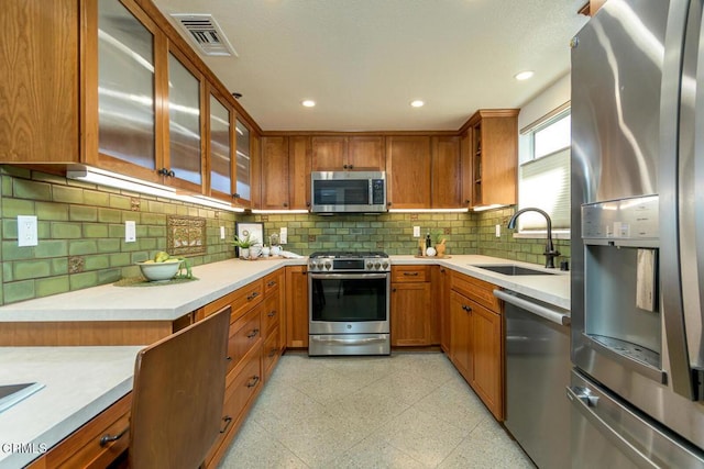 kitchen featuring sink, backsplash, and appliances with stainless steel finishes