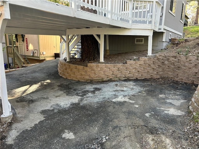 view of patio featuring cooling unit and a deck